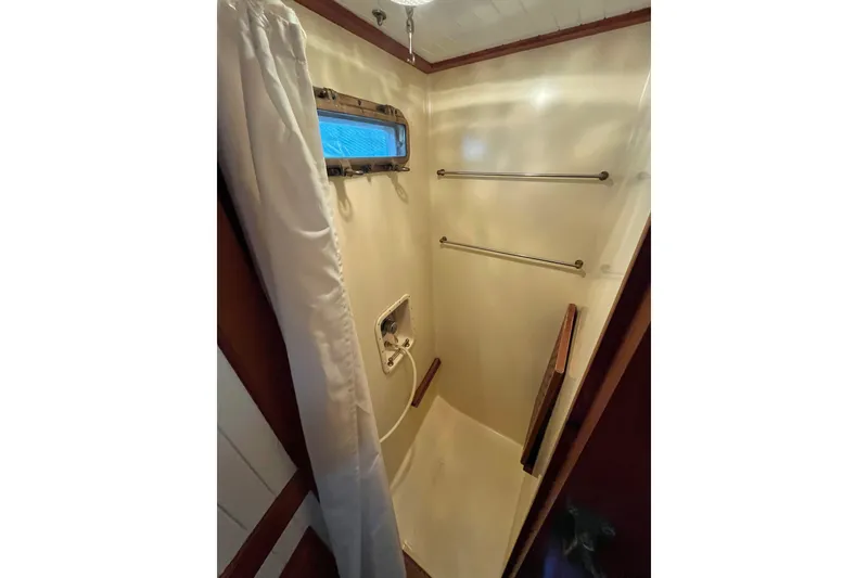 Slide: The Image of Compact shower area in 1987 Liberty Gatsby boat with curtain and towel racks. - 10
