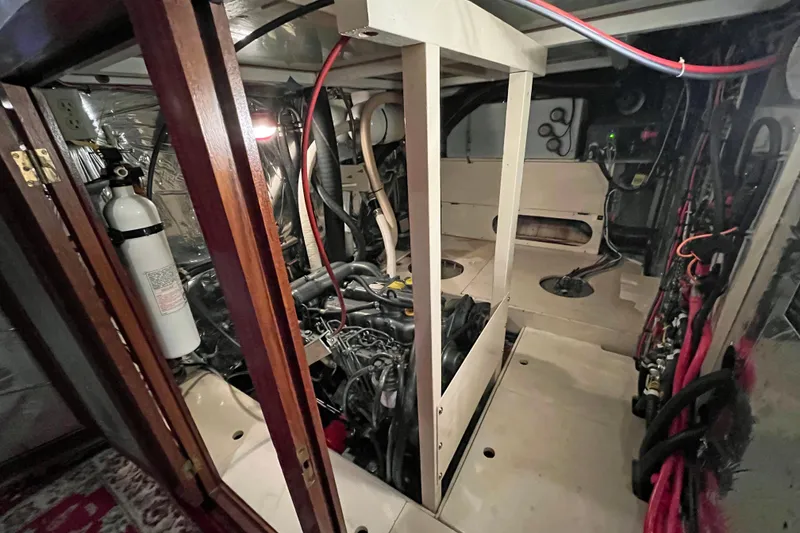 Slide: The Image of Engine room of a 1987 Liberty Gatsby boat, featuring wiring and fire extinguisher. - 15