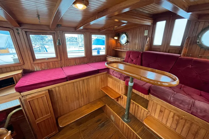 Slide: The Image of Luxurious 1987 Liberty Gatsby yacht interior with wood paneling and plush red seating. - 18