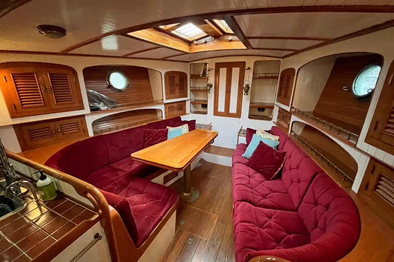 Slide: The Image of Luxurious 1987 Liberty Gatsby yacht interior with plush red seating and wooden accents. - 2