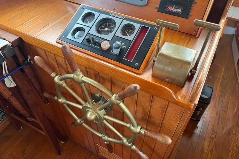 Slide: The Image of 1987 Liberty Gatsby boat helm with wooden wheel and control panel. - 21