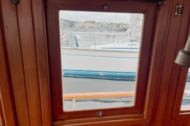 Slide: The Image of View from Liberty Gatsby 1987 boat window overlooking marina and sailboats. - 25