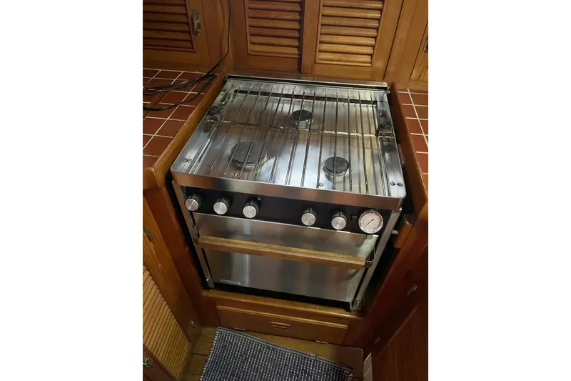 Slide: The Image of 1987 Liberty Gatsby stove with stainless steel finish in a wooden kitchen setting. - 26