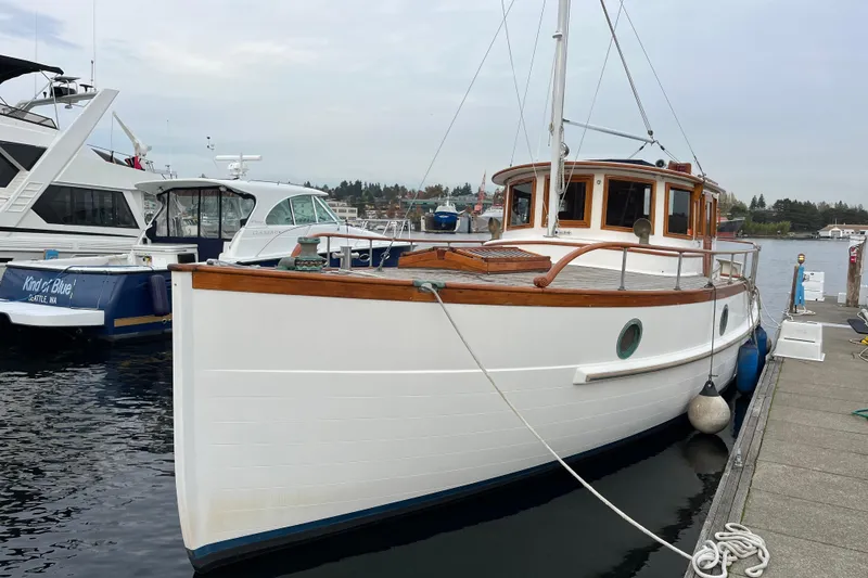 Slide: The Image of Vintage 1987 Liberty Gatsby boat docked at marina, featuring classic wooden design. - 29