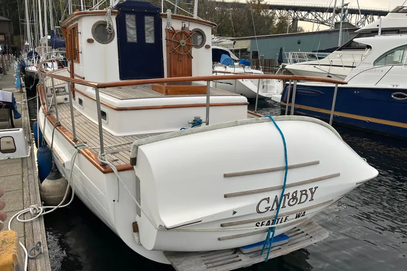 Slide: The Image of 1987 Liberty Gatsby boat docked in Seattle marina, featuring wooden railings and classic design. - 31