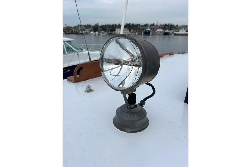 Slide: The Image of Vintage Liberty Gatsby 1987 boat spotlight on deck, overlooking marina. - 36
