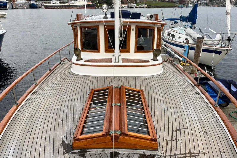 Slide: The Image of 1987 Liberty Gatsby boat with wooden deck, docked at a marina. - 38