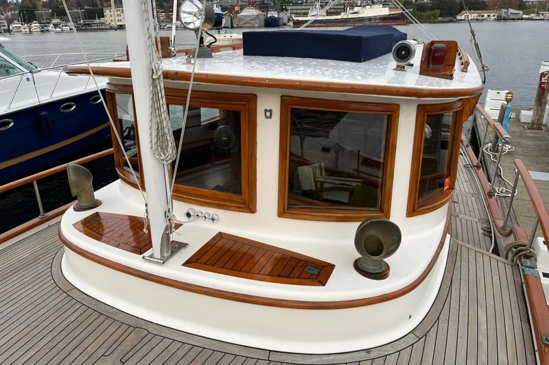 Slide: The Image of 1987 Liberty Gatsby yacht with wooden accents docked at a marina. - 39