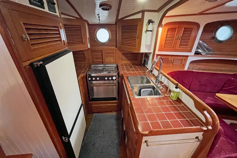 Slide: The Image of Interior of 1987 Liberty Gatsby yacht with wooden cabinetry and compact kitchen. - 4