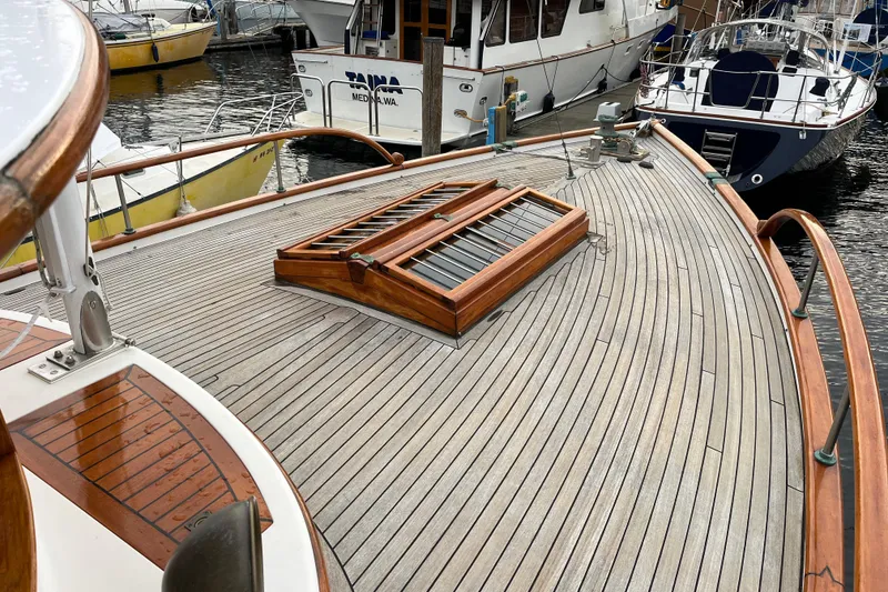 Slide: The Image of Wooden deck of 1987 Liberty Gatsby yacht, docked with other boats in marina. - 41