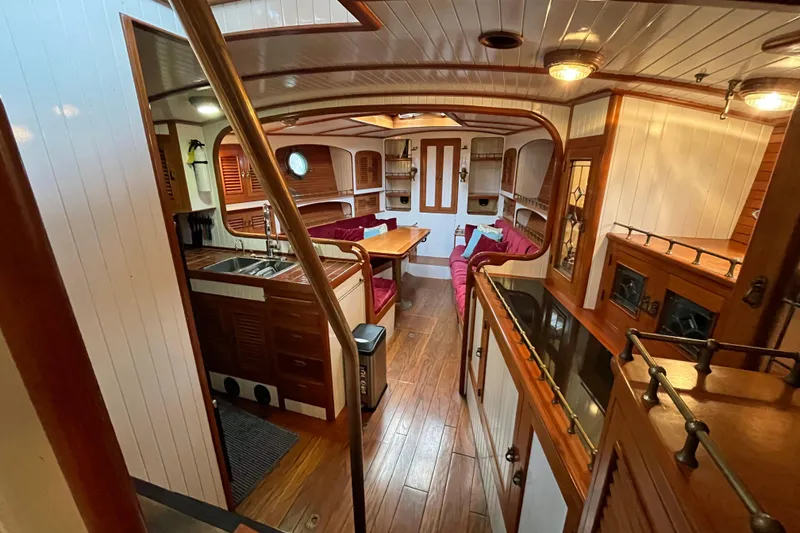 Slide: The Image of Interior of 1987 Liberty Gatsby yacht with wood paneling and cozy seating area. - 6