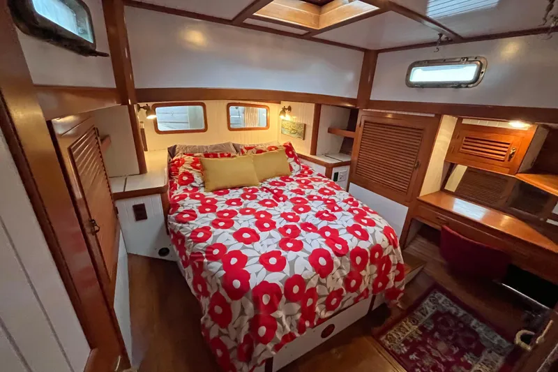 Slide: The Image of Cozy 1987 Liberty Gatsby yacht cabin with floral bedding and wooden interior. - 8