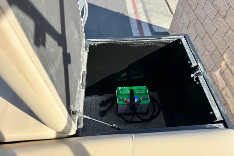 Slide: The Image of Battery compartment of 2020 Bentley Pontoons 223 Cruise, featuring a green battery. - 19