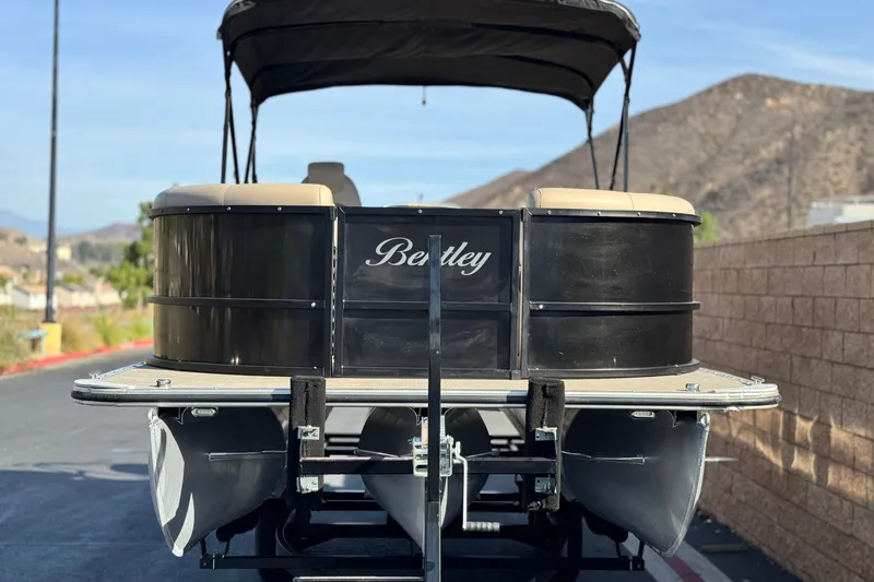 Slide: The Image of 2020 Bentley Pontoons 223 Cruise pontoon boat on trailer, scenic mountain backdrop. - 2