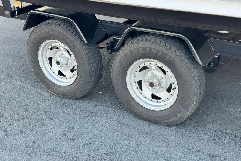 Slide: The Image of Trailer wheels of a 2020 Bentley Pontoons 223 Cruise on asphalt surface. - 24