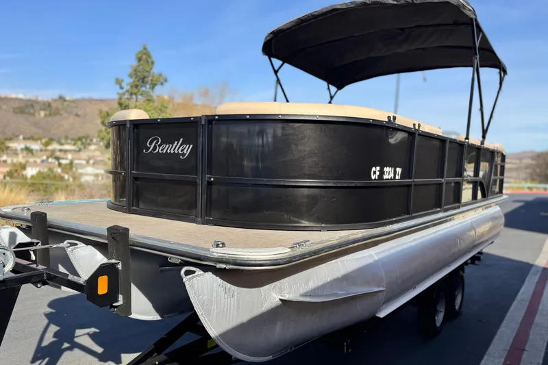 Slide: The Image of 2020 Bentley Pontoons 223 Cruise on trailer, black exterior, parked outdoors. - 3