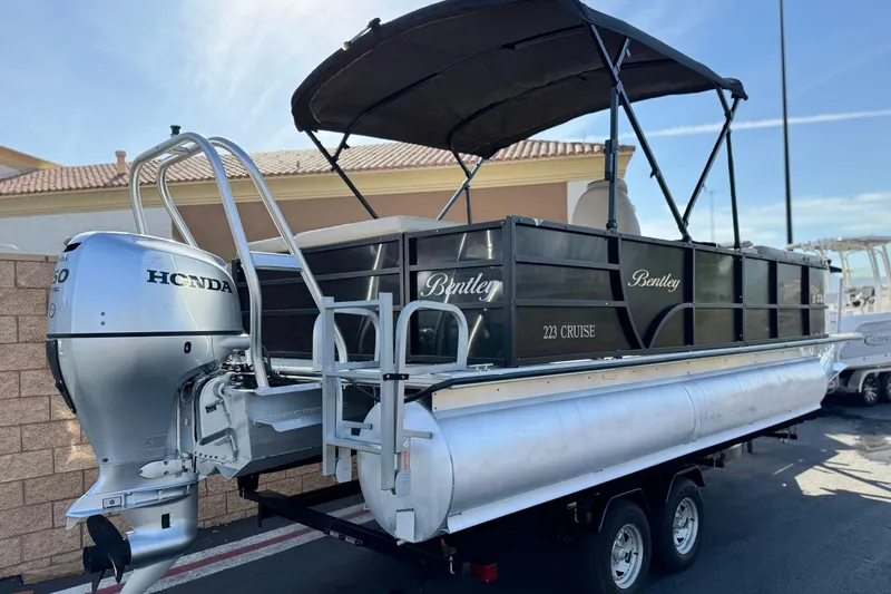 Slide: The Image of 2020 Bentley Pontoons 223 Cruise with Honda outboard motor on trailer. - 6