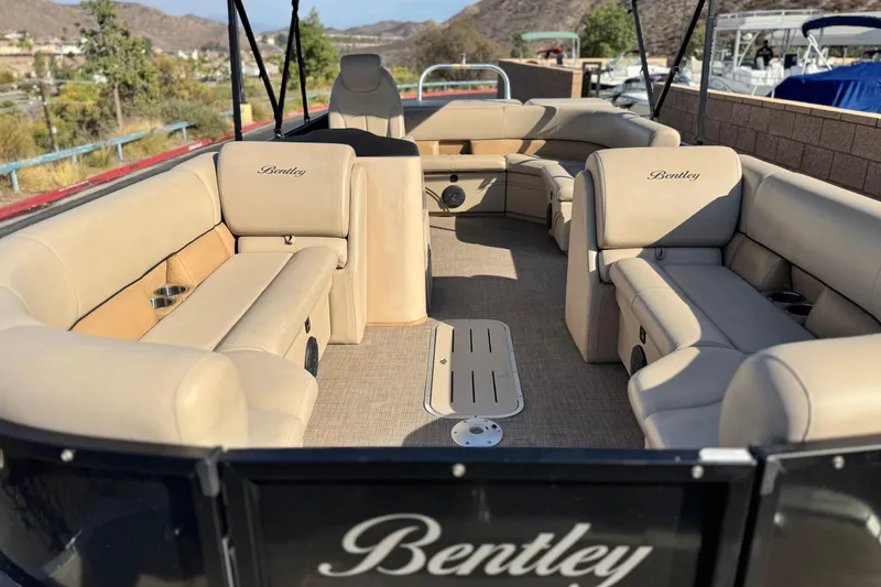 Slide: The Image of 2020 Bentley Pontoons 223 Cruise interior with beige seating and scenic background. - 9