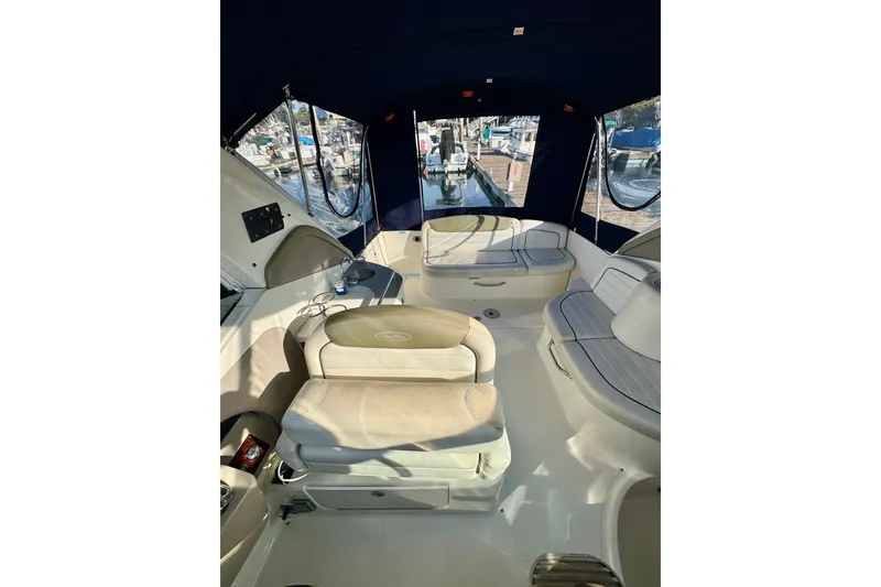 Slide: The Image of 2007 Sea Ray 290 Sundancer boat interior with seating and marina view. - 11