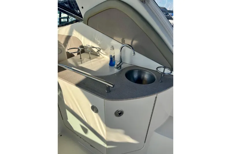 Slide: The Image of 2007 Sea Ray 290 Sundancer boat kitchenette with sink and cup holders. - 13