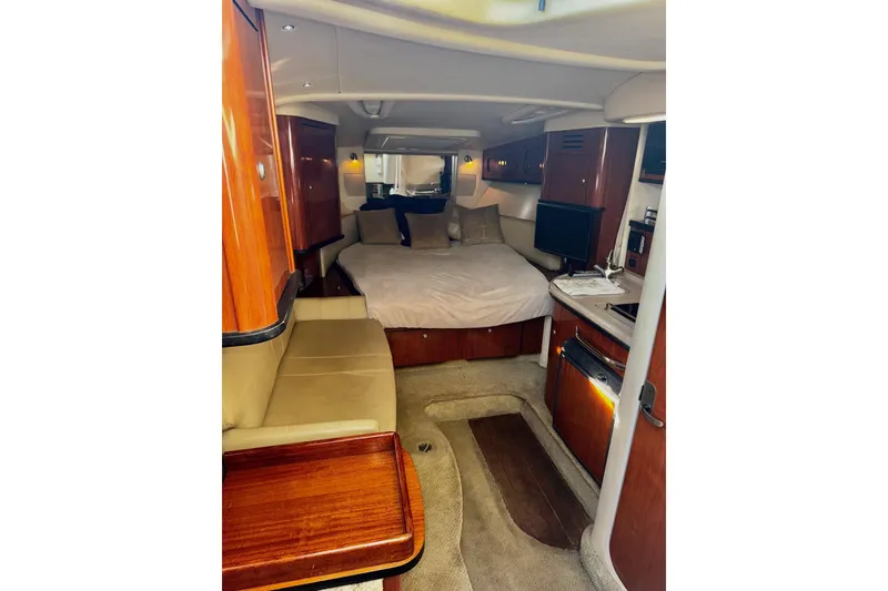 Slide: The Image of Luxurious interior of 2007 Sea Ray 290 Sundancer with cozy bed and elegant wood finishes. - 17