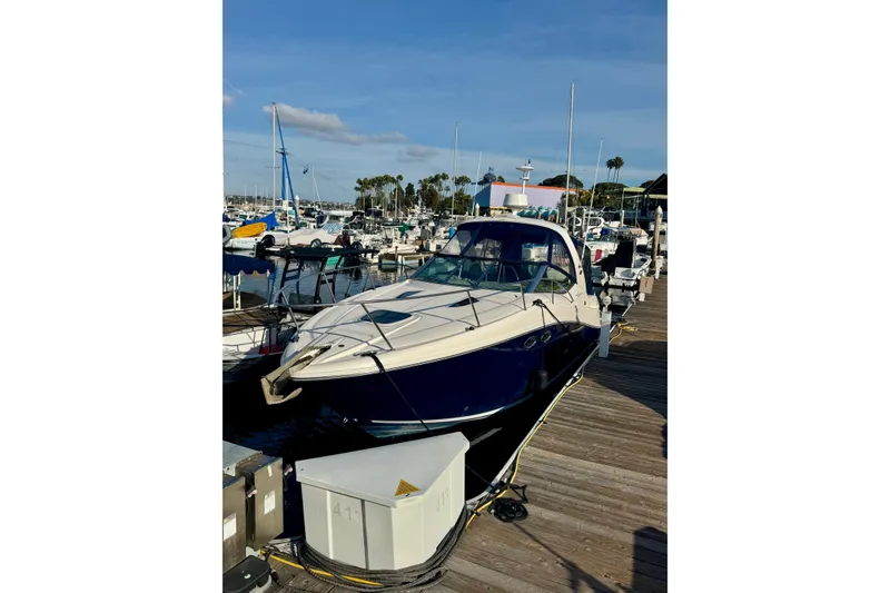Slide: The Image of 2007 Sea Ray 290 Sundancer docked at a marina under a clear blue sky. - 3