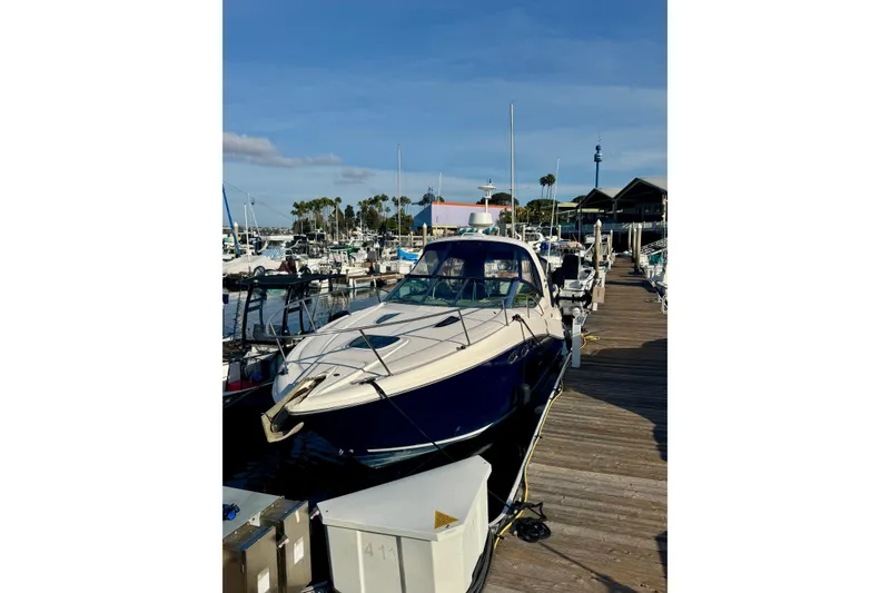Slide: The Image of 2007 Sea Ray 290 Sundancer docked at a marina under a clear blue sky. - 4