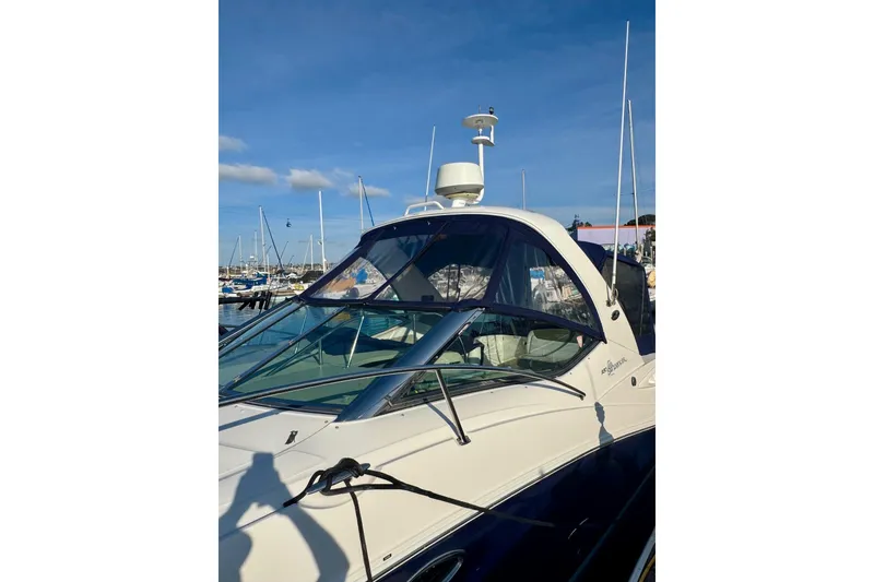 Slide: The Image of 2007 Sea Ray 290 Sundancer boat docked at marina under clear blue sky. - 9