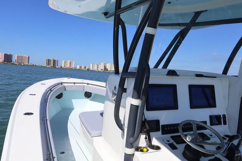 Slide: The Image of 2017 Contender 35 ST boat interior with navigation controls, cruising near city skyline. - 11