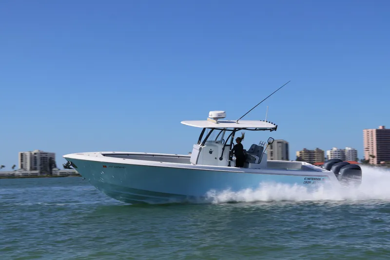 Slide: The Image of 2017 Contender 35 ST boat cruising on water with city skyline in background. - 14