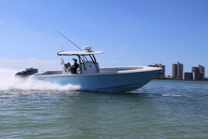 Slide: The Image of 2017 Contender 35 ST boat speeding on water with city skyline in background. - 15