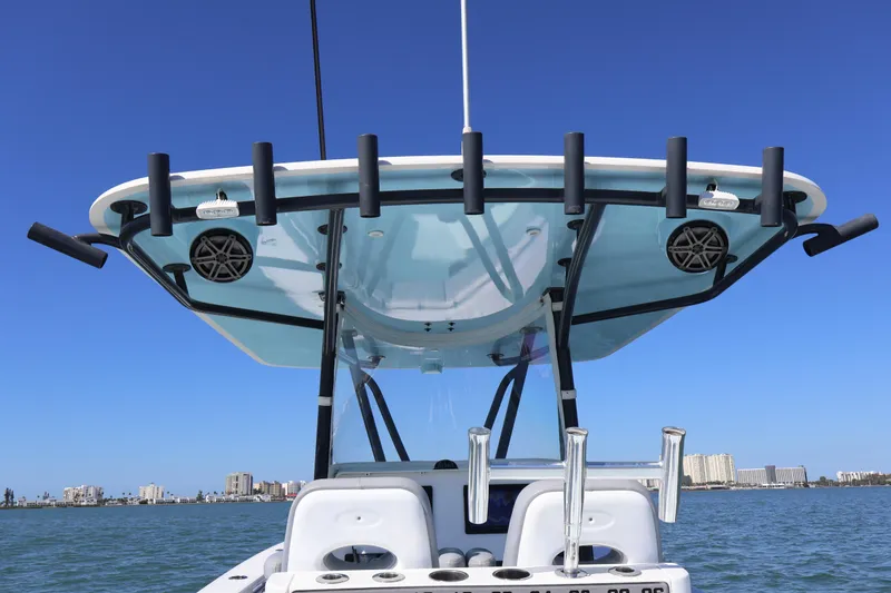Slide: The Image of 2017 Contender 35 ST boat with rod holders and speakers, against a clear blue sky. - 8