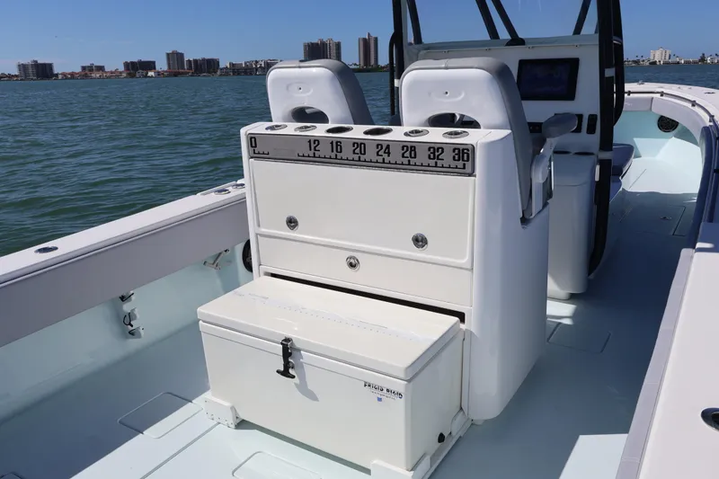 Slide: The Image of 2017 Contender 35 ST boat interior with seating and storage, on calm water. - 9