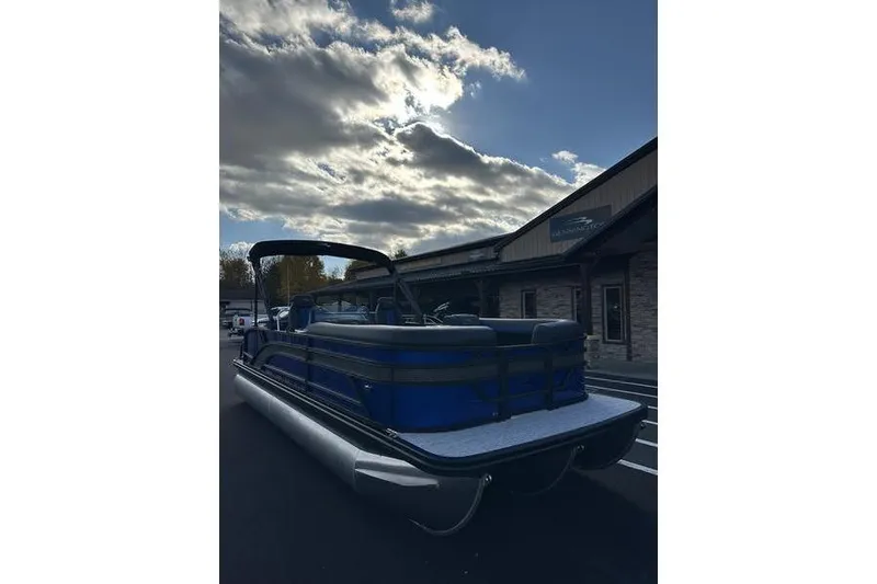 Slide: The Image of 2026 Bennington S Swingback 22 SSB pontoon boat under cloudy sky. - 4