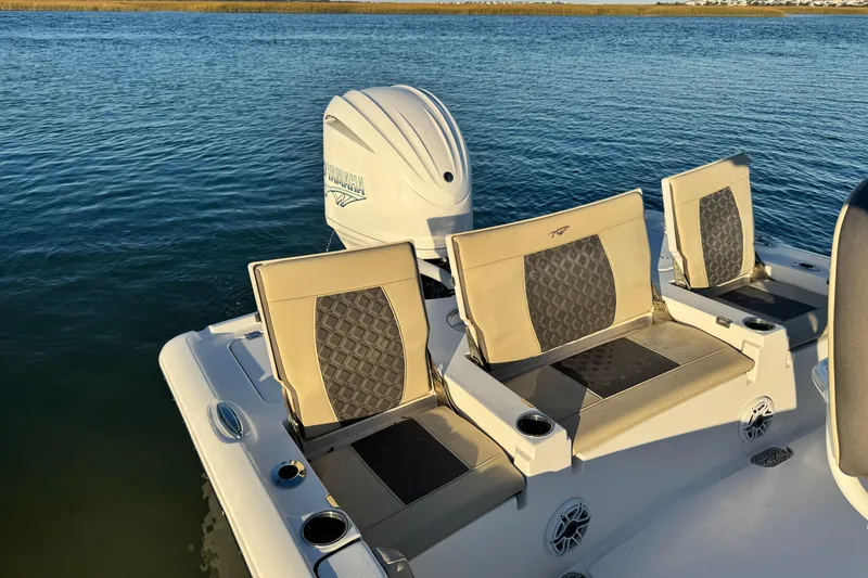 Slide: The Image of 2023 Tidewater 2500 Carolina Bay boat seats and Yamaha engine on calm water. - 11