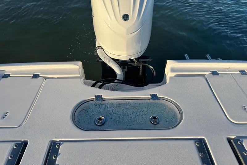 Slide: The Image of 2023 Tidewater 2500 Carolina Bay boat stern with outboard motor and water view. - 14