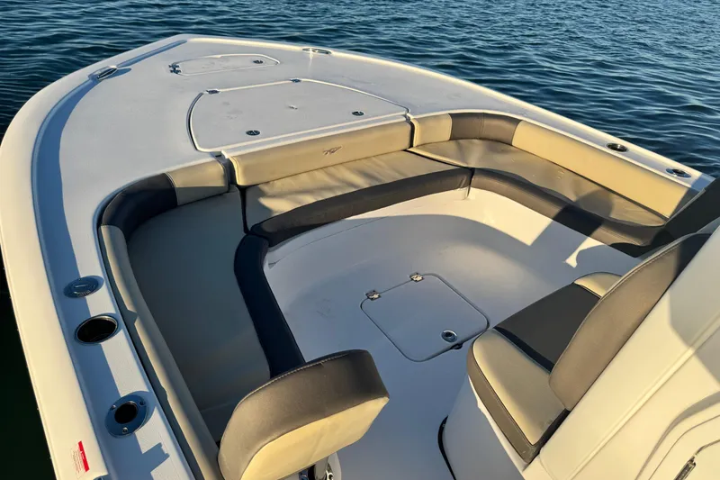 Slide: The Image of 2023 Tidewater 2500 Carolina Bay boat interior with cushioned seating and storage compartments. - 19