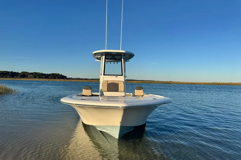 Slide: The Image of 2023 Tidewater 2500 Carolina Bay boat on calm water under clear blue sky. - 5