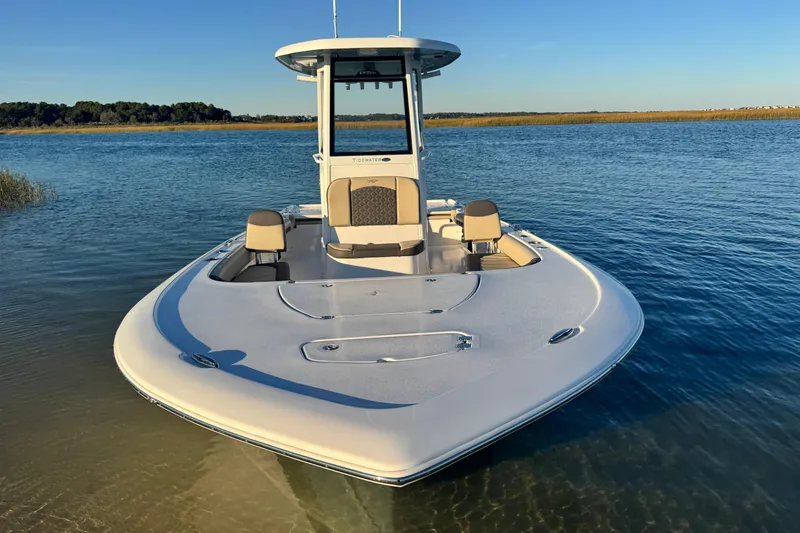Slide: The Image of 2023 Tidewater 2500 Carolina Bay boat on calm water, showcasing sleek design. - 7