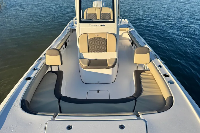 Slide: The Image of 2023 Tidewater 2500 Carolina Bay boat interior with cushioned seating on calm water. - 8