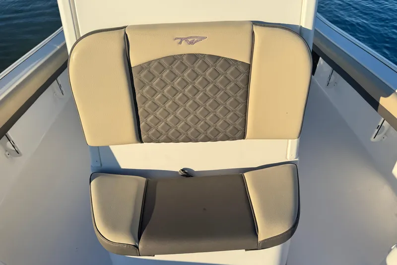 Slide: The Image of 2023 Tidewater 2500 Carolina Bay boat seat with beige and gray upholstery. - 9