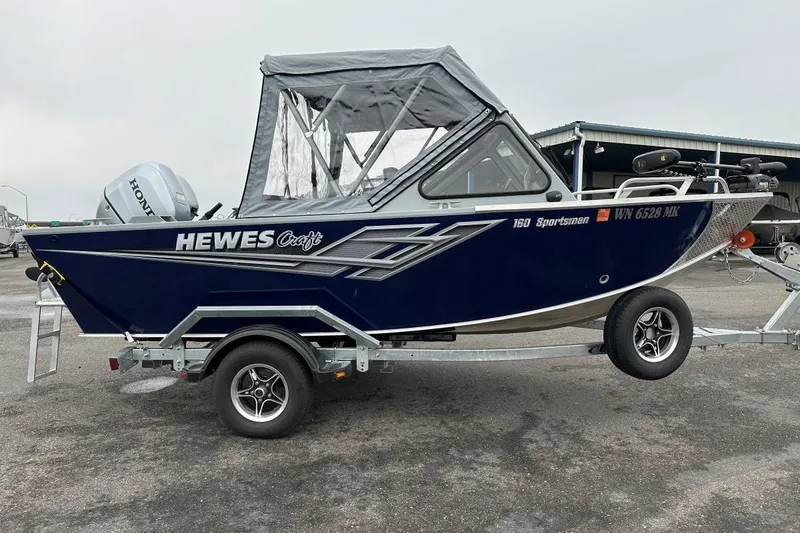 Slide: The Image of 2025 Hewescraft 160 Sportsman boat on trailer, featuring a Honda outboard motor. - 1