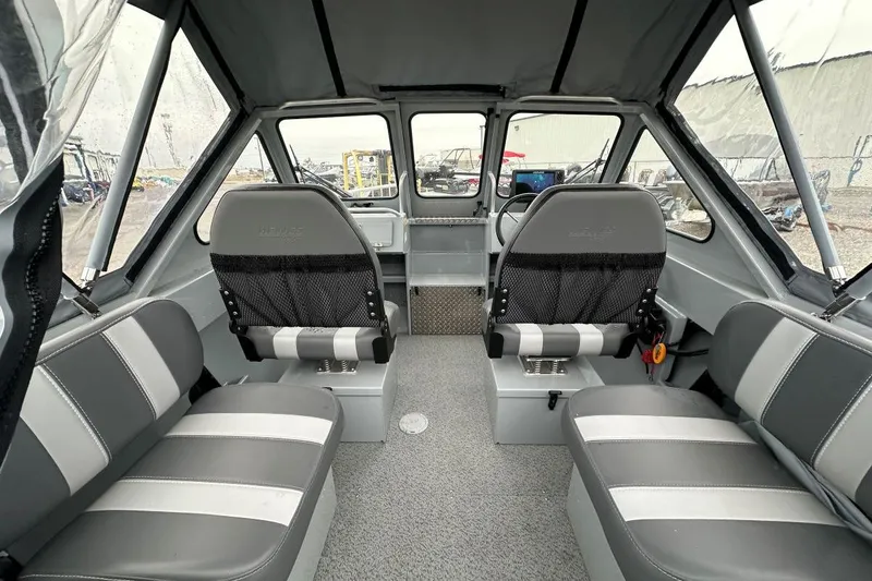 Slide: The Image of 2025 Hewescraft 160 Sportsman interior with gray seating and modern dashboard. - 6