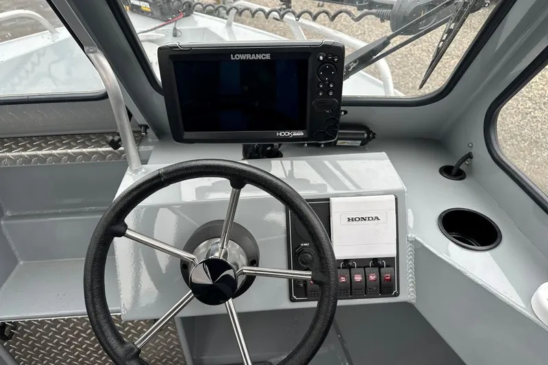 Slide: The Image of 2025 Hewescraft 160 Sportsman boat dashboard with steering wheel and Lowrance display. - 7