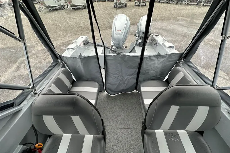 Slide: The Image of 2025 Hewescraft 160 Sportsman interior with gray seating and dual outboard motors. - 8