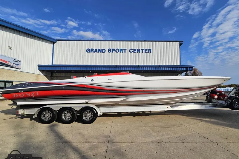 The Image of 2008 Donzi 38 ZR speedboat on trailer at Grand Sport Center, clear sky background. - 1