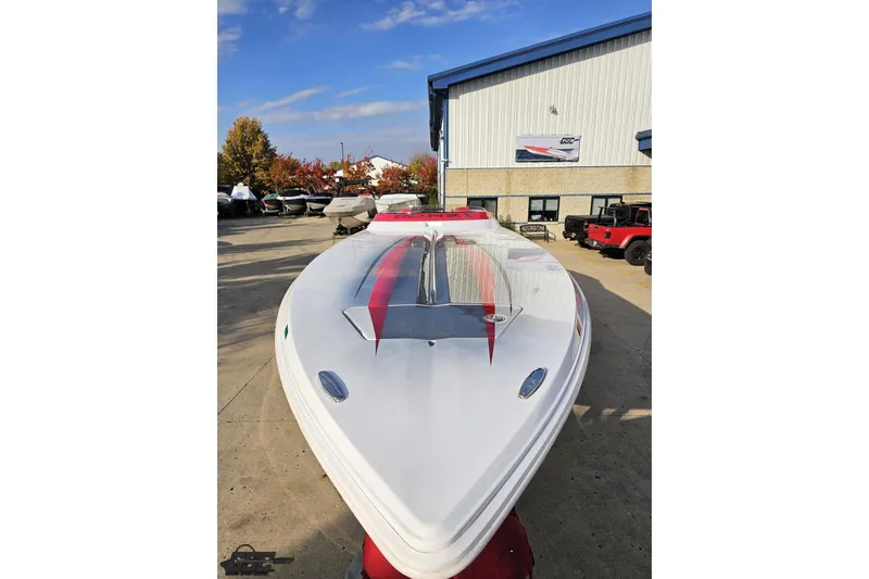 Slide: The Image of 2008 Donzi 38 ZR speedboat with sleek design, parked outdoors under clear sky. - 15