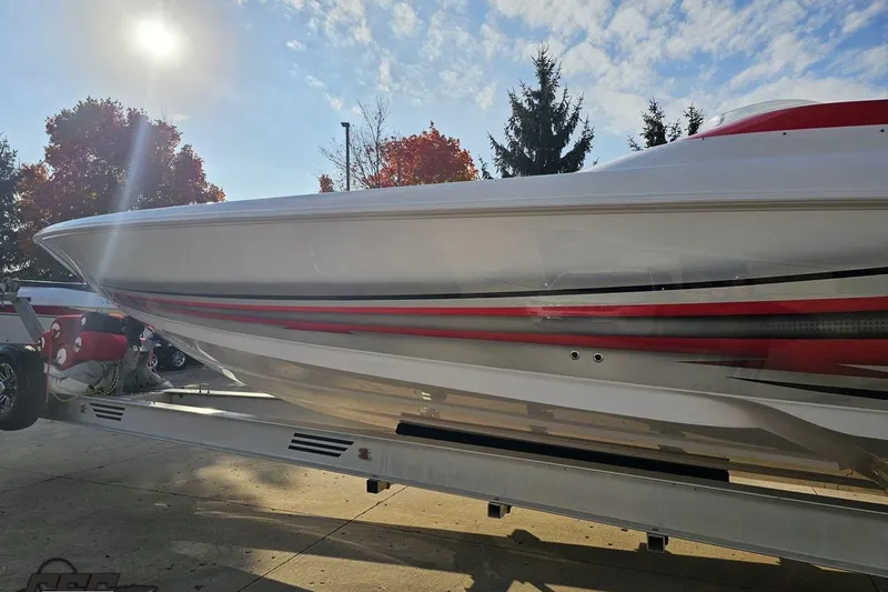 Slide: The Image of 2008 Donzi 38 ZR boat on trailer under sunny sky with autumn trees. - 22