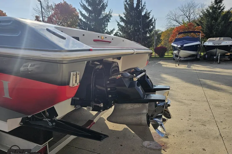Slide: The Image of 2008 Donzi 38 ZR boat with powerful dual propellers, parked outdoors on a sunny day. - 27