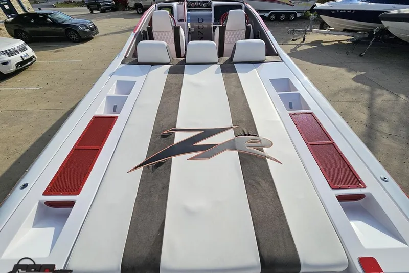 Slide: The Image of 2008 Donzi 38 ZR speedboat with sleek design and red accents, docked outdoors. - 32